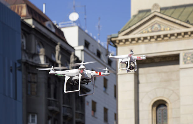 bigstock-Two-Drone-To-Fly-In-The-City-83844149