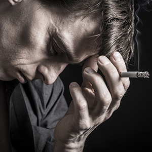 bigstock-Depressed-man-smoking-cigarett-59434430