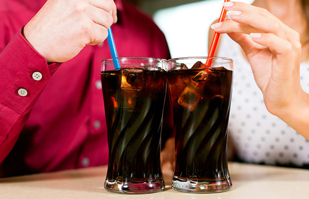 bigstock-Couple-drinking-soda-in-a-bar--25701170