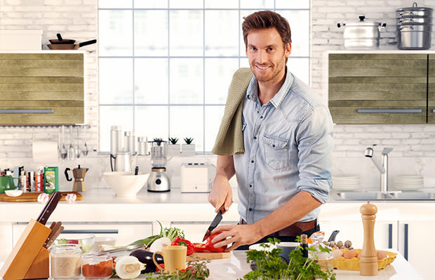 bigstock-Happy-handsome-man-cooking-in--65016658