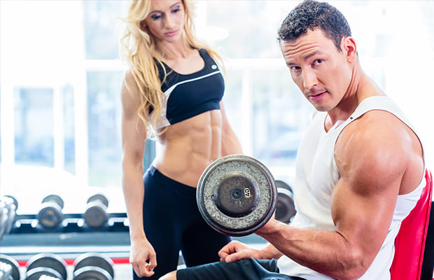 bigstock-Couple-in-fitness-gym-with-dum-80614703