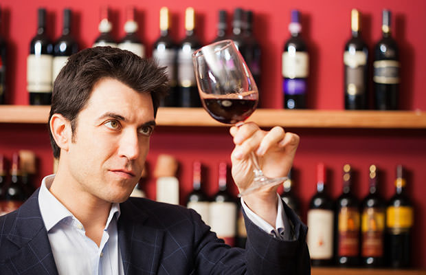 bigstock-Man-tasting-a-glass-of-red-win-75324970