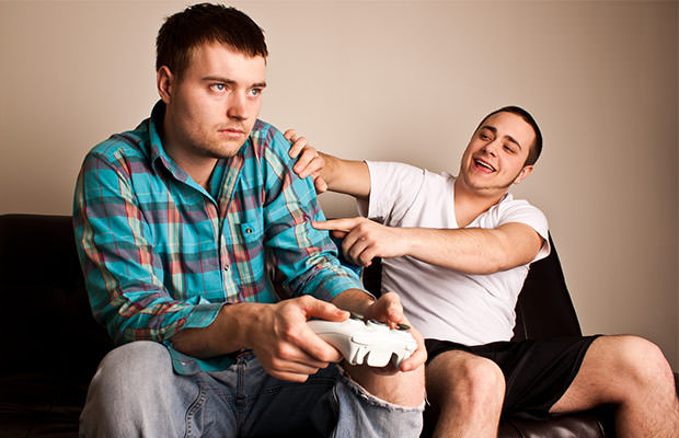 bigstock-Two-Guys-Playing-VG-Shove-24079853