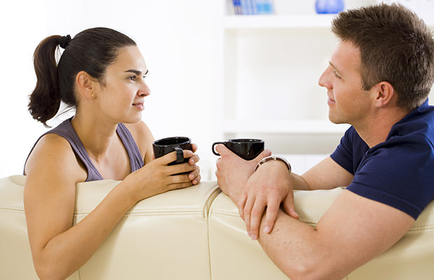 Couple having a conversation on the sofa