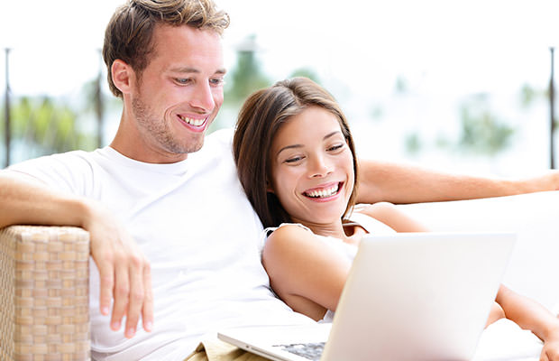 bigstock-Couple-in-sofa-with-laptop-pc--52049530