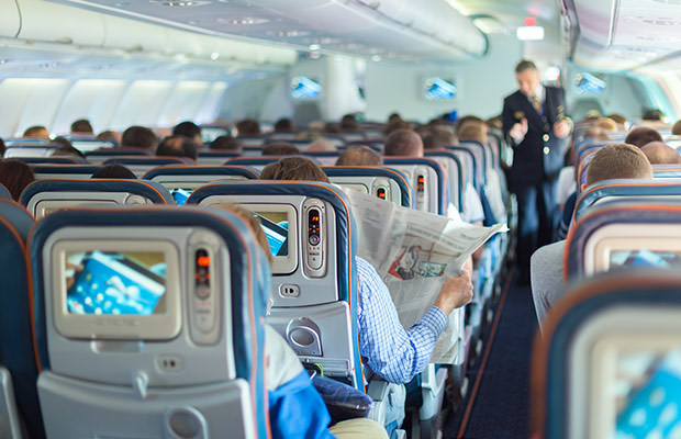 bigstock-Steward-and-passengers-on-comm-110677163