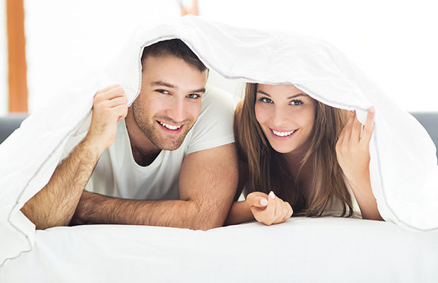 bigstock-Couple-under-bed-covers-91283300